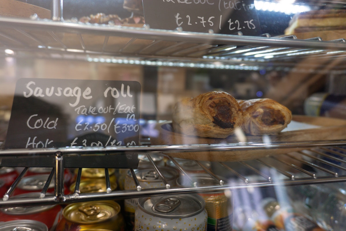 A fridge with food and soft drinks inside